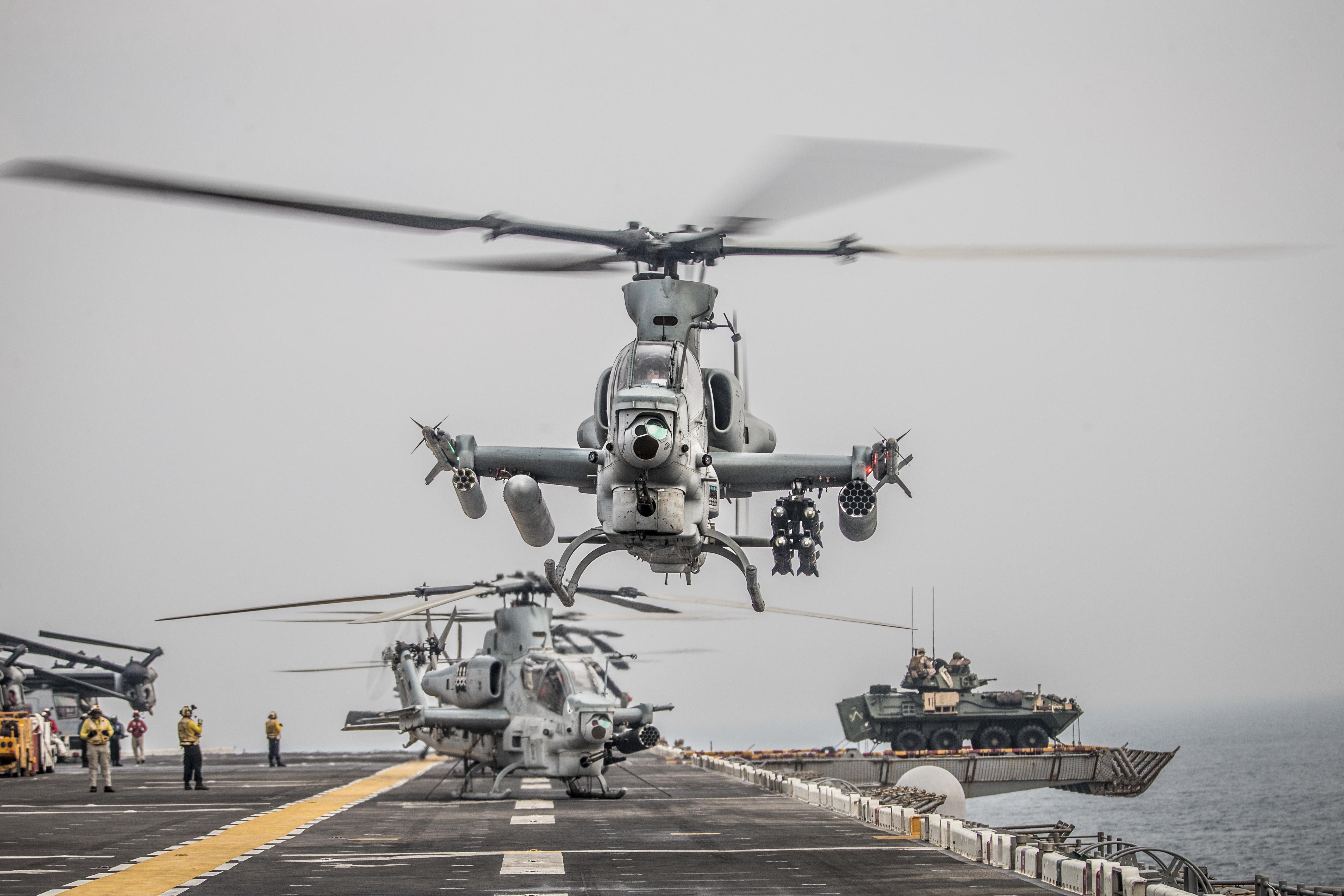 A Row Of Bell Ah 1Z Viper Helicopters Take Off From The Amphibious